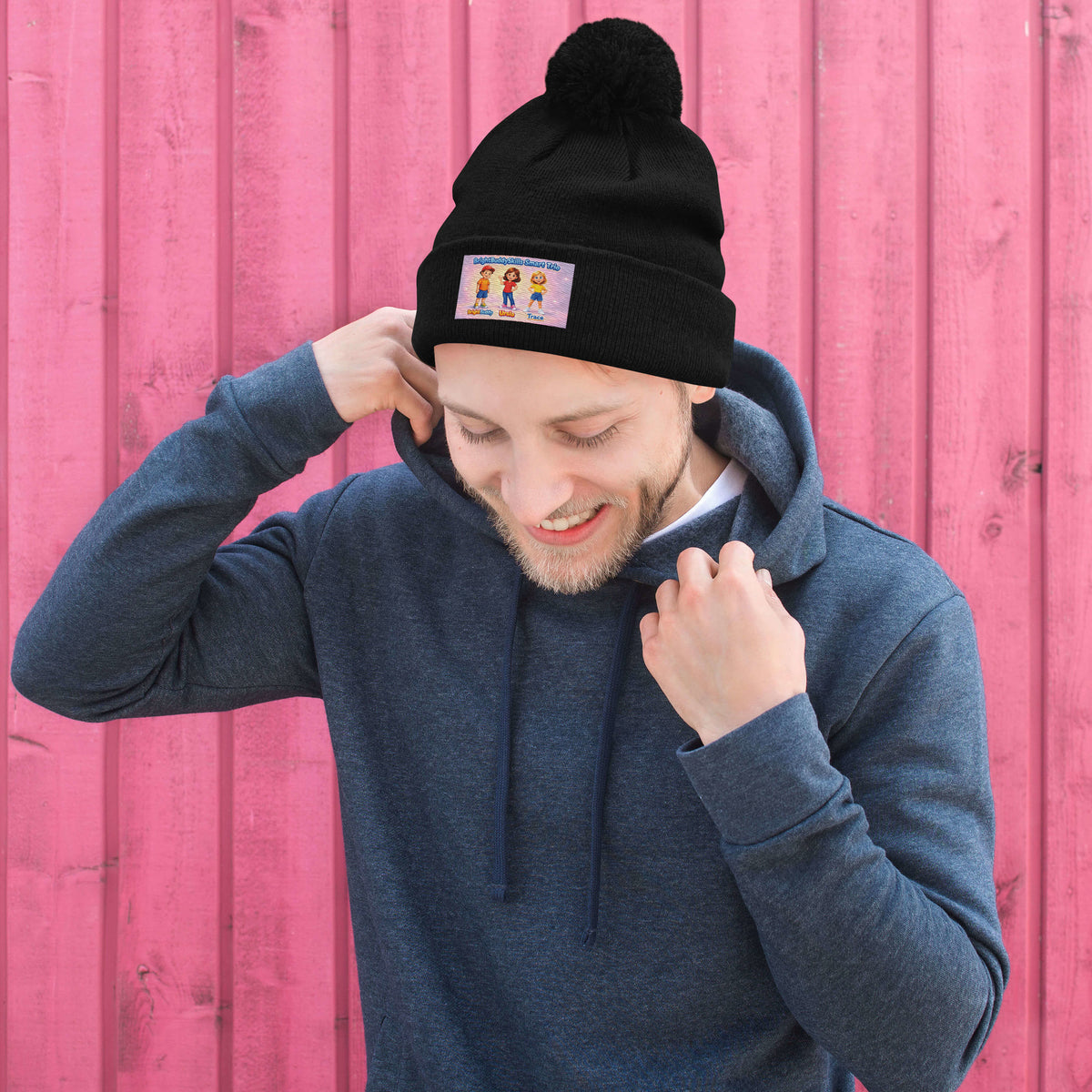 BrightBuddySkills Smart Trio pom-pom knit beanie, black, front view — product mockup